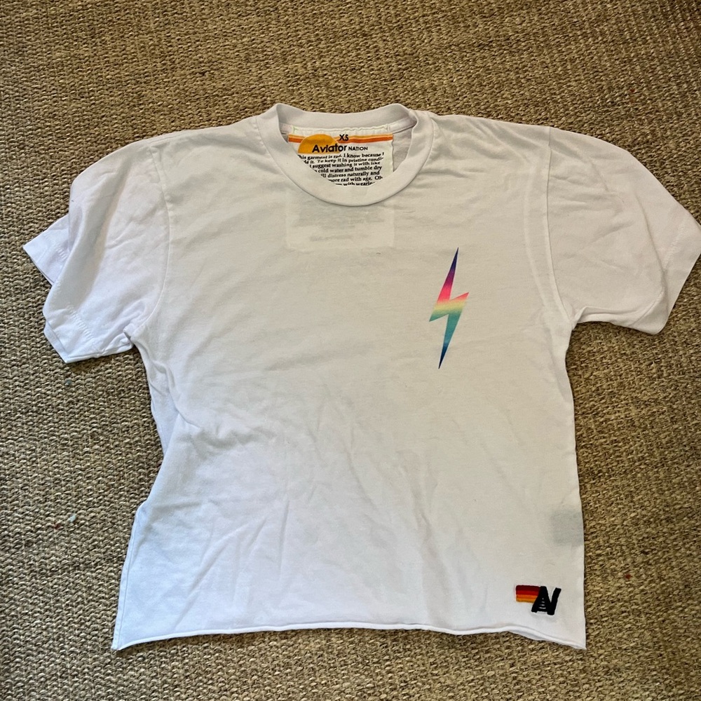 white AV shirt with neon lightning bolt on side